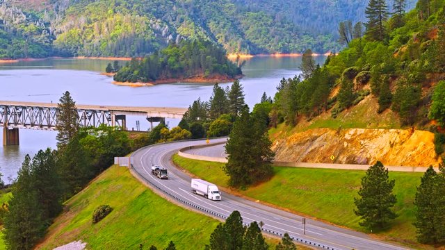 Vehicles driving on Pit River Bridge double deck road and rail bridge over Shasta Lake in Shasta County, California, with Interstate 5 on upper and Union Pacific Railroad on lower deck