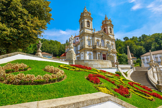 Tenoes near Braga. Sanctuary of Bom Jesus do Monte in neoclassical style and prospective view of bloom gardens in a sunny day, blue sky. Popular landmark and pilgrimage site in northern Portugal.