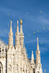 Fototapeta na wymiar Yellow balloons flying over Milan cathedral, Italy, during the manifestation, called In The Name of Africa, against the hunger in the world