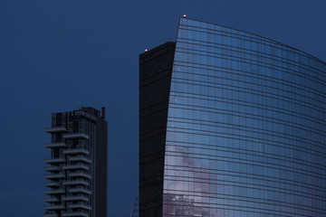 Modern office building with glass facade at dusk
