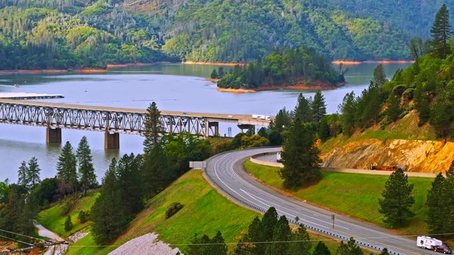 Vehicles driving on Pit River Bridge double deck road and rail bridge over Shasta Lake in Shasta County, California, with Interstate 5 on upper and Union Pacific Railroad on lower deck