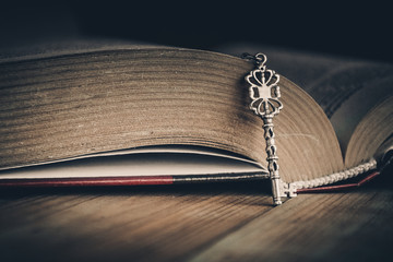 Open book with a silver key