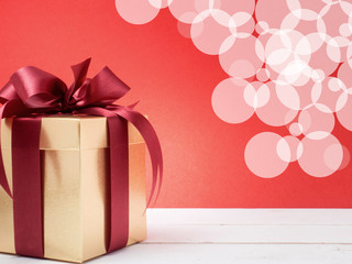 Valentine festival , New year Gold gift box with red ribbon. Red background for create idea copy space.