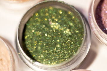 Cosmetics. Pigments for make-up, eyes, lips, face and body. Brilliant radiant, scattered multicolored powders.