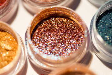 Cosmetics. Pigments for make-up, eyes, lips, face and body. Brilliant radiant, scattered multicolored powders.