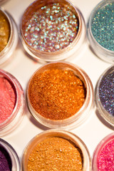 Cosmetics. Pigments for make-up, eyes, lips, face and body. Brilliant radiant, scattered multicolored powders.