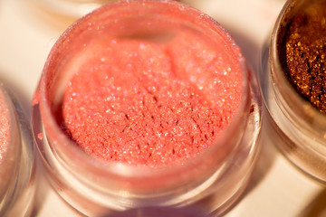 Cosmetics. Pigments for make-up, eyes, lips, face and body. Brilliant radiant, scattered multicolored powders.