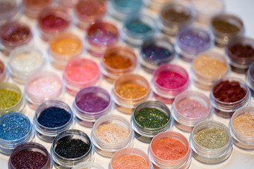 Cosmetics. Pigments for make-up, eyes, lips, face and body. Brilliant radiant, scattered multicolored powders.