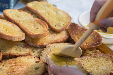 Preparing Slices of Grilled Bread with Olive Oil, Italian Snack