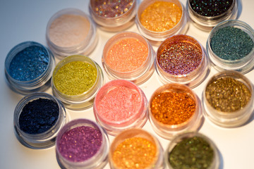 Cosmetics. Pigments for make-up, eyes, lips, face and body. Brilliant radiant, scattered multicolored powders.