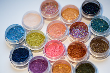 Cosmetics. Pigments for make-up, eyes, lips, face and body. Brilliant radiant, scattered multicolored powders.