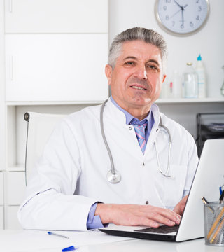 Mature doctor in his office