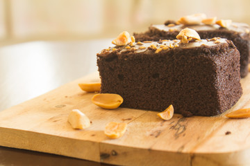 Shock Chocolate brownies with nuts on a wooden floor. 