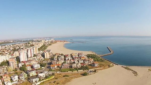 Aerial view of Constanta , major city on the Black Sea coast, Eastern Europe , with lakes in the background and Mamaia holiday resort,  drone footage