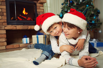brother and sister in santa hat