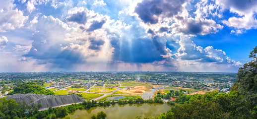 Landscape afternoon in a small town with sun rays through the clouds seen from above as beautiful paintings