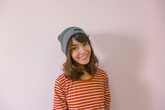A fashion portrait of young hipster asian woman wearing sweater and beanie knit ha