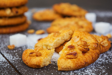 Cookies with peanuts on dark wooden background
