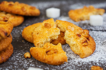 Cookies with peanuts on dark wooden background