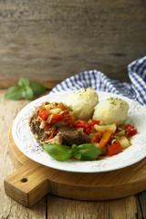 Meat served with vegetable stew and potato dumplings