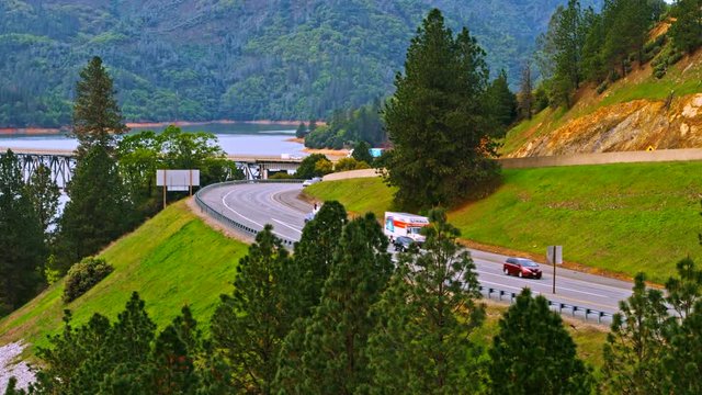 Vehicles driving on Pit River Bridge double deck road and rail bridge over Shasta Lake in Shasta County, California, with Interstate 5 on upper and Union Pacific Railroad on lower deck