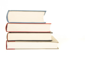 Straight staple of four books seen from the front isolated on a white background