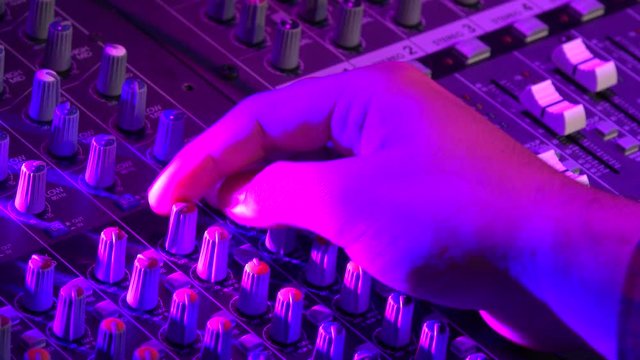 Hand Sound engineer making settings on a professional mixing desk