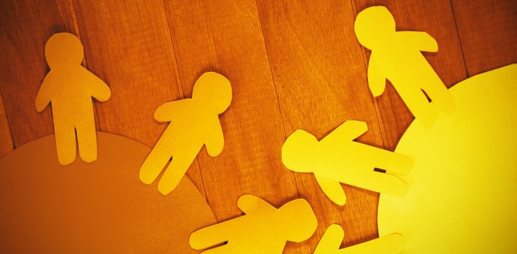 Blue and yellow paper cut out figures on table