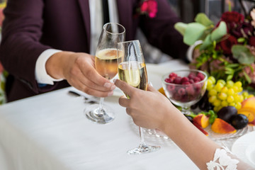 Celebration of the wedding day with glasses of champagne. The bride is toasting with champagne