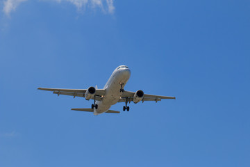 Fototapeta na wymiar Passenger Airplane Taking Off Into The Blue Sky