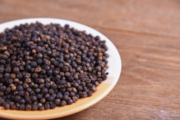 black pepper on old wooden table