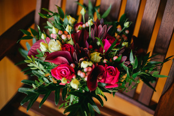 wedding bouquet at wooden chair