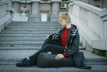 Beautiful girl in coat. With old case for violin in a hand. © Vladimir Arndt