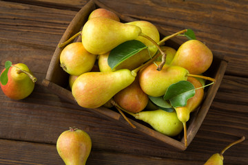 Fresh organic pears in wooden bowl
