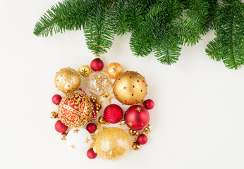 Christmas ball with bow hanging on fresh evergreen fir tree of a collection of small pieces for decoration