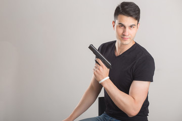 Elegant man with gun, wearing black shirt