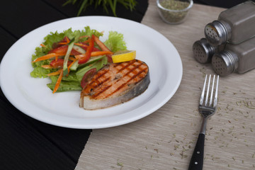 piece of trout on a plate, red fish grill, restaurant food