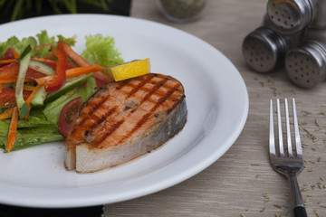 piece of trout on a plate, red fish grill, restaurant food
