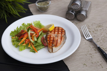 piece of trout on a plate, red fish grill, restaurant food