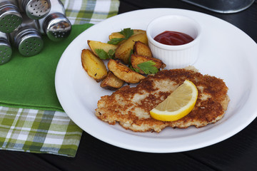 fish cutlet and baked potatoes