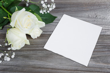 Bouquet of white rose and paper card