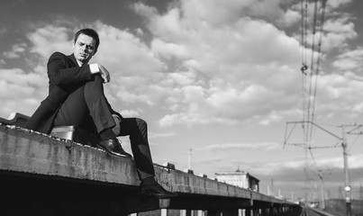 A man in a suit sits alone. Sad mood. The concept of dismissal from work. Depression, moral...