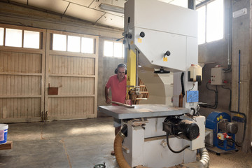 carpenter cutting a wooden board