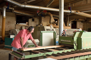 carpenter polishing wood in a carpentry workshop