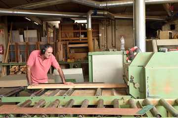 carpenter polishing wood in a carpentry workshop