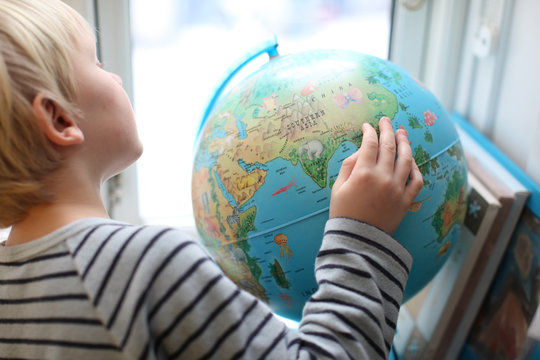 Boy looking at globe