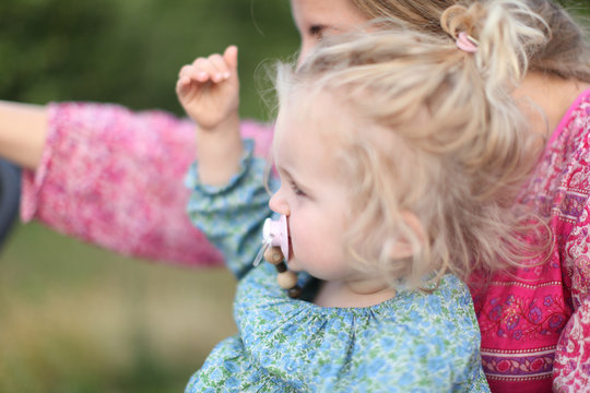 mother and girl together enjoying the view, nordic summer, strong colours