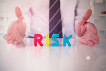 Composite image of mid section of businessman with colorful risk