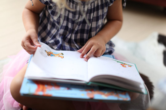 girl reading, child studying children's book