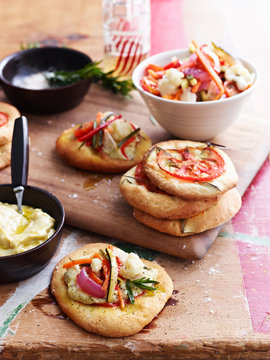 Mini pizza bread topped with giadineira, on chopping board